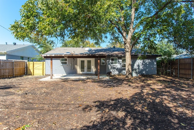 rear view of property featuring french doors