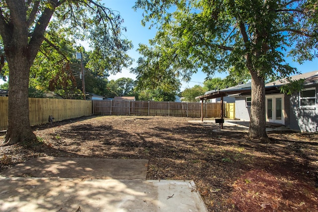 view of yard featuring french doors and a patio area