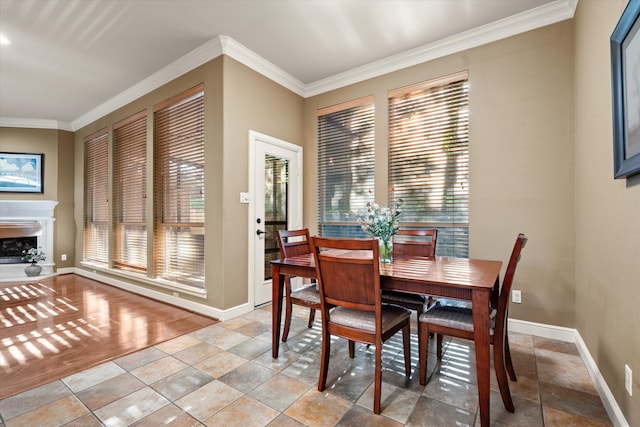 dining space with light hardwood / wood-style flooring and crown molding