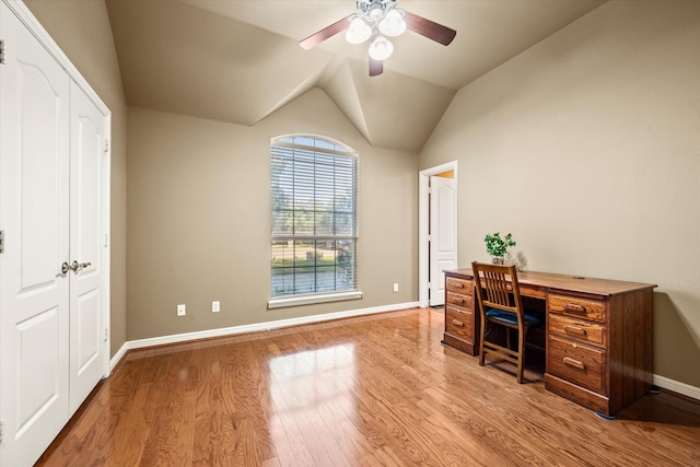 home office with light hardwood / wood-style flooring, ceiling fan, and vaulted ceiling