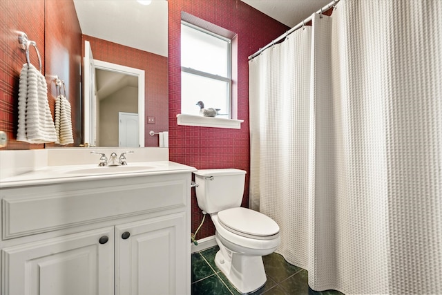 bathroom featuring vanity, a shower with shower curtain, tile patterned floors, and toilet