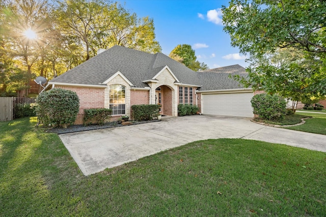 ranch-style home with a garage and a front yard