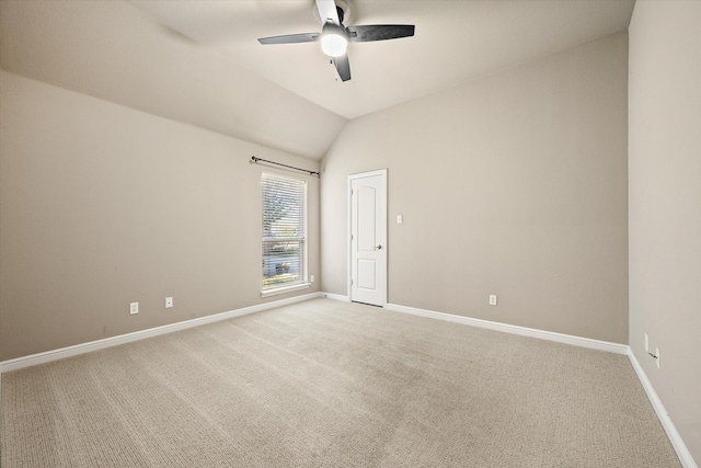 carpeted empty room with lofted ceiling and ceiling fan