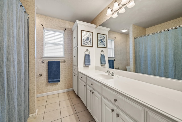 bathroom featuring toilet, vanity, and tile patterned flooring