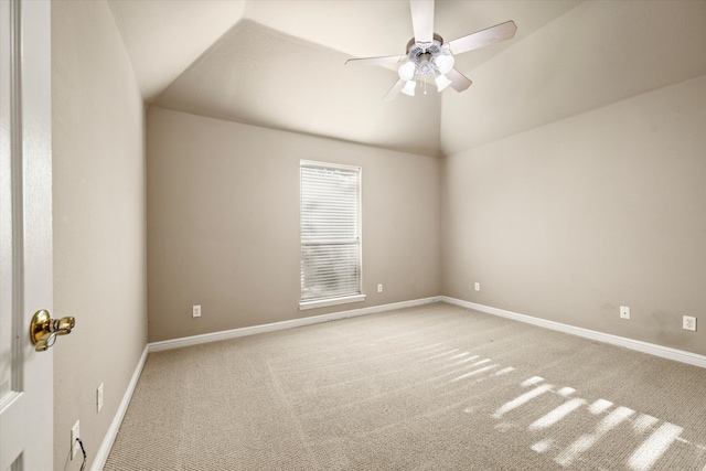 carpeted empty room featuring ceiling fan and vaulted ceiling