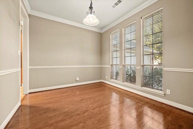 spare room featuring hardwood / wood-style flooring and crown molding