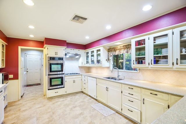 kitchen with tasteful backsplash, sink, and stainless steel appliances