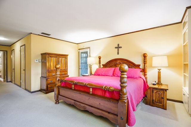 bedroom with ornamental molding and light carpet