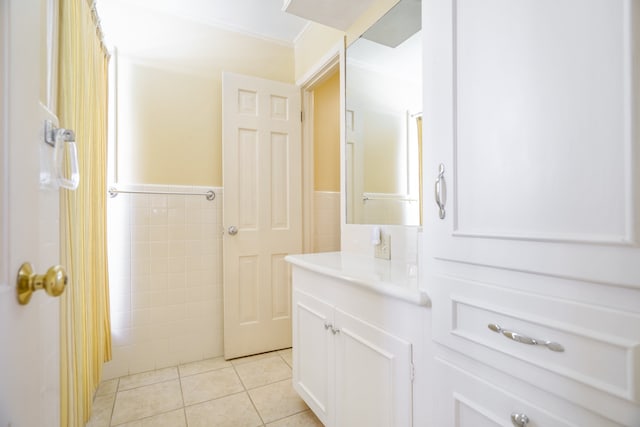 bathroom featuring tile walls, tile patterned floors, and ornamental molding