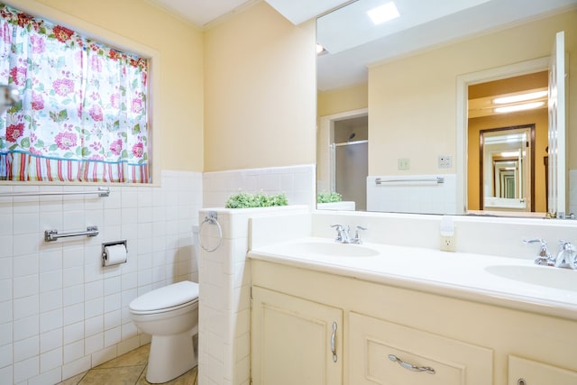 bathroom featuring tile walls, tile patterned floors, walk in shower, vanity, and toilet