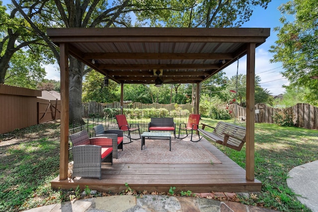 wooden deck featuring ceiling fan and a lawn