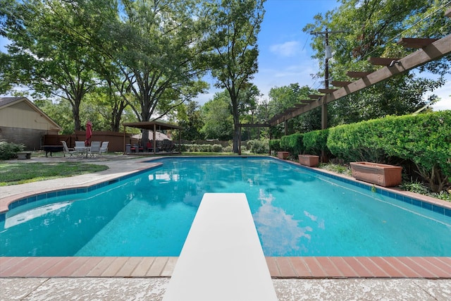 view of pool with a diving board, a gazebo, and a patio area