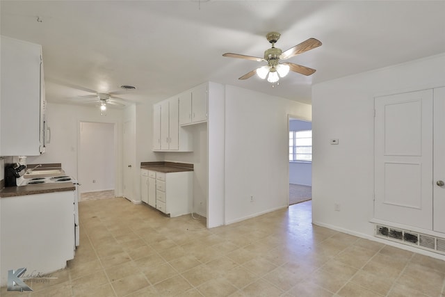 kitchen featuring white range with electric stovetop, white cabinetry, and ceiling fan