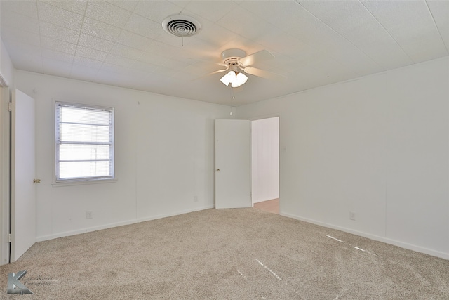 carpeted empty room featuring ceiling fan