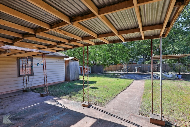 view of yard featuring a patio area and a storage shed