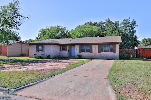 ranch-style home with a front lawn