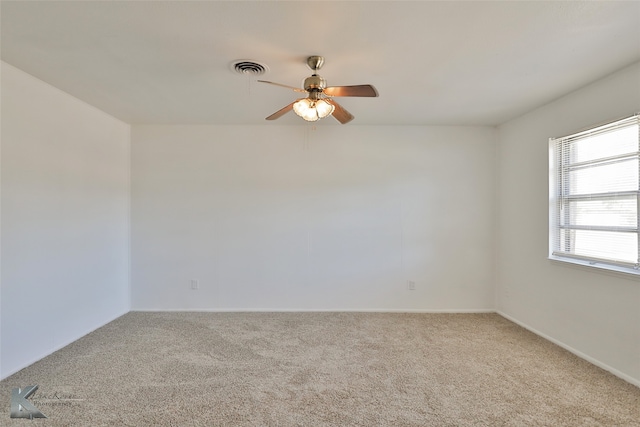 empty room featuring ceiling fan and light carpet