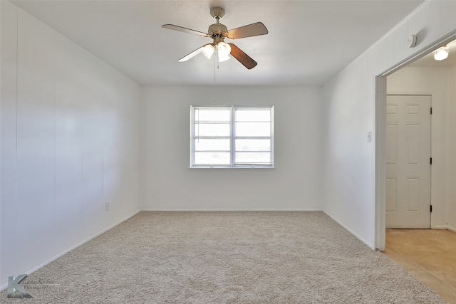 carpeted spare room featuring ceiling fan