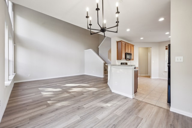 kitchen with light hardwood / wood-style flooring and a chandelier