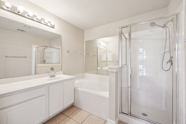 bathroom featuring independent shower and bath, vanity, and tile patterned flooring