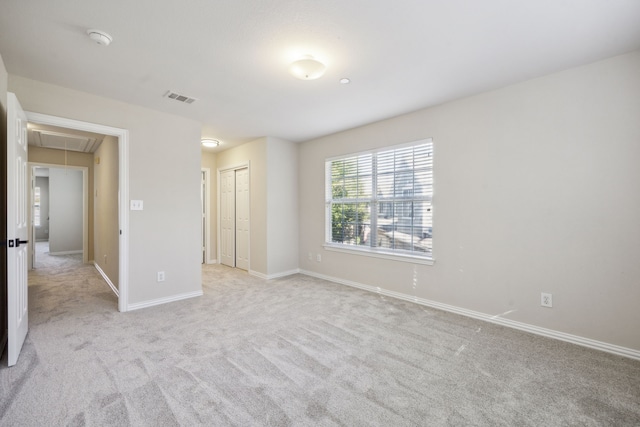 spare room with light colored carpet