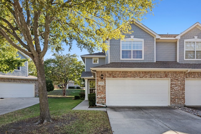 view of front of property featuring a front lawn and a garage