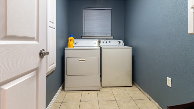 clothes washing area with separate washer and dryer and light tile patterned floors