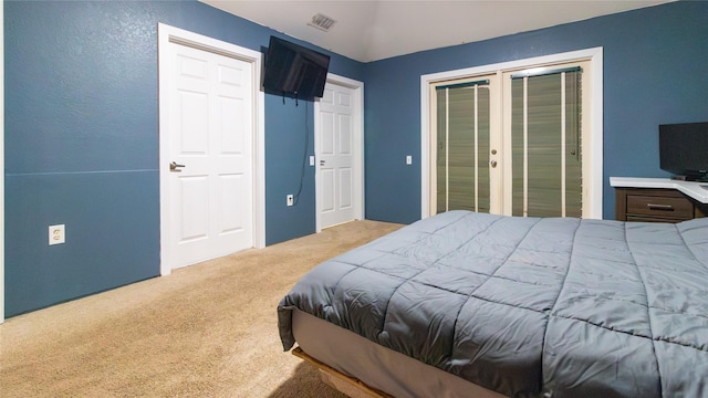 bedroom featuring access to exterior, french doors, and light colored carpet