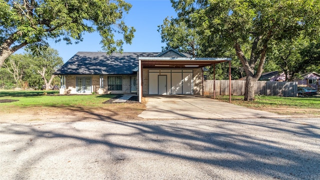 view of front of property featuring a carport and a front lawn