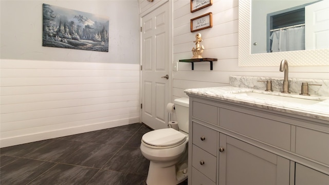 bathroom with a shower with shower curtain, tile patterned floors, vanity, and toilet