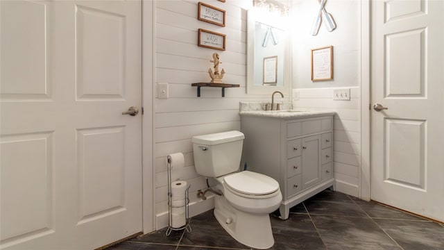 bathroom featuring tile patterned flooring, vanity, and toilet