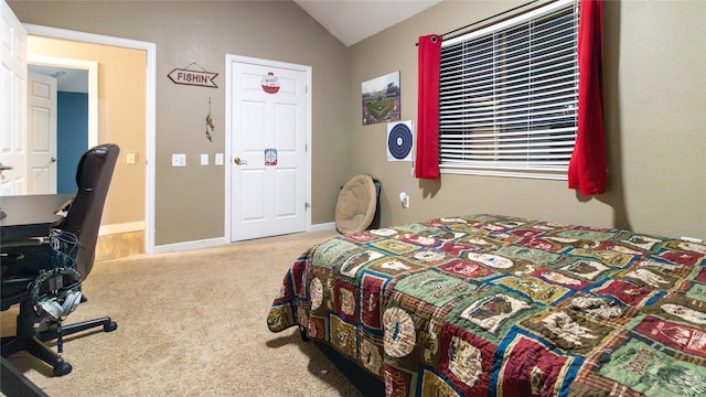 bedroom featuring light colored carpet and lofted ceiling