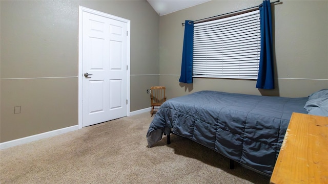 carpeted bedroom featuring lofted ceiling