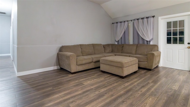 living room featuring dark hardwood / wood-style flooring and vaulted ceiling