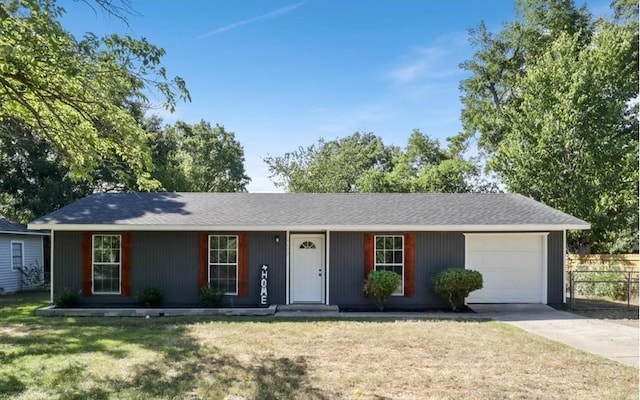 ranch-style house featuring a garage and a front lawn