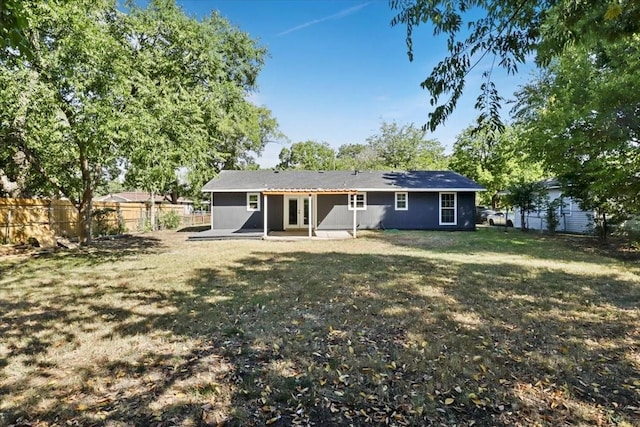 back of house featuring a patio area and a lawn