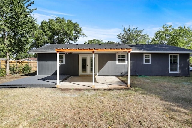 back of property featuring a yard and a patio area