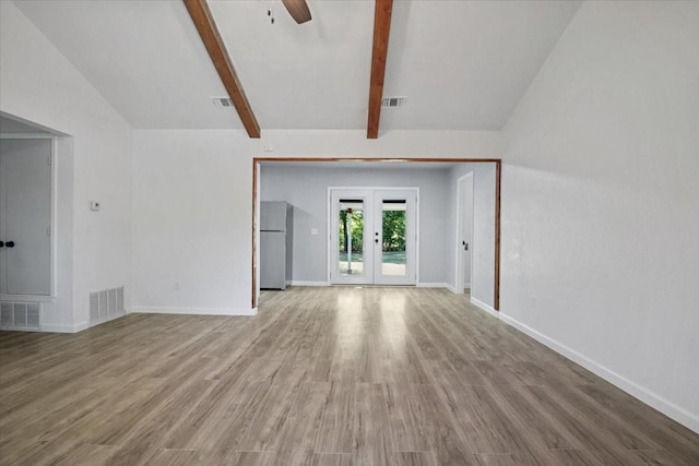 unfurnished living room with french doors, hardwood / wood-style floors, vaulted ceiling with beams, and ceiling fan