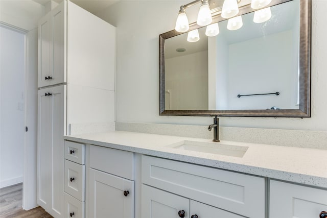 bathroom with vanity and hardwood / wood-style flooring