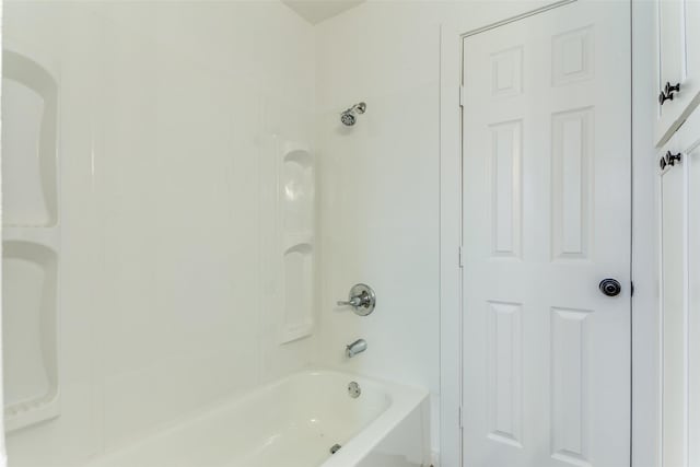 bathroom with bathing tub / shower combination