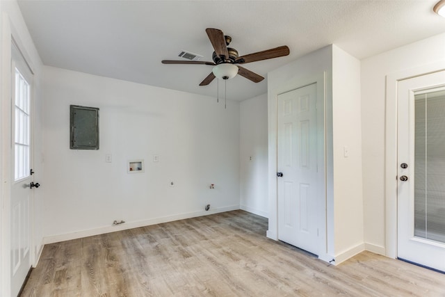 interior space with electric panel, ceiling fan, and light wood-type flooring