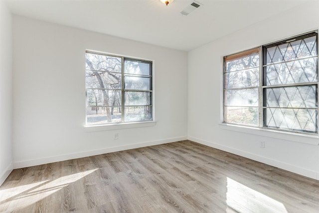 spare room featuring light hardwood / wood-style floors