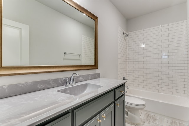 full bathroom with vanity, toilet, and tiled shower / bath