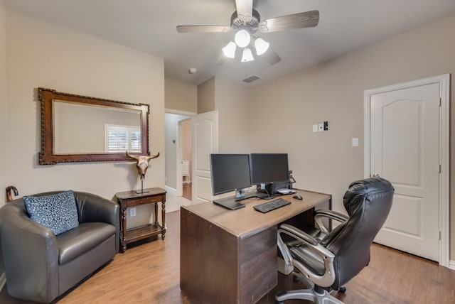 home office with ceiling fan and light hardwood / wood-style flooring