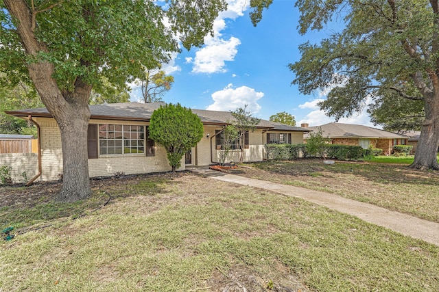 ranch-style home with a front yard