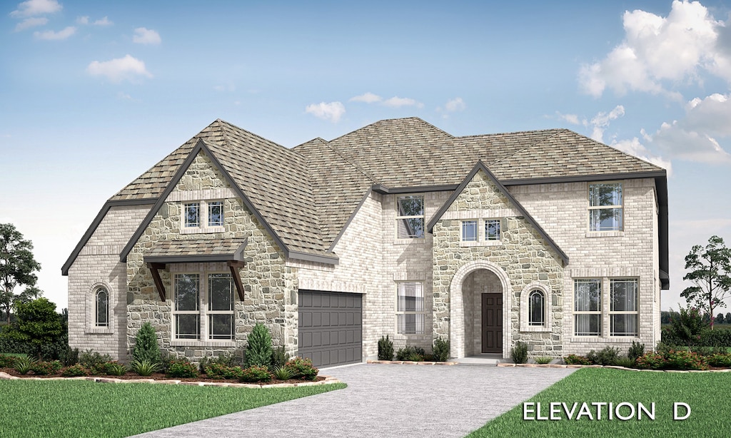 view of front of home with a garage and a front lawn