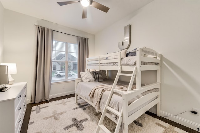 bedroom featuring wood finished floors, baseboards, and ceiling fan