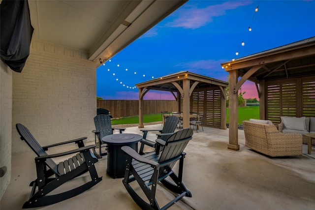 patio terrace at dusk featuring an outdoor hangout area and a gazebo