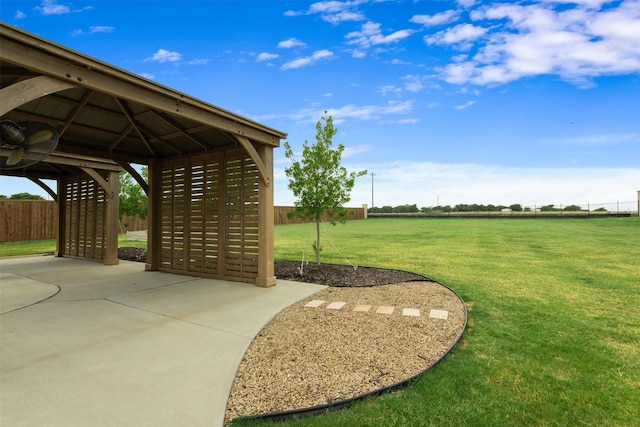 view of home's community featuring a lawn and fence