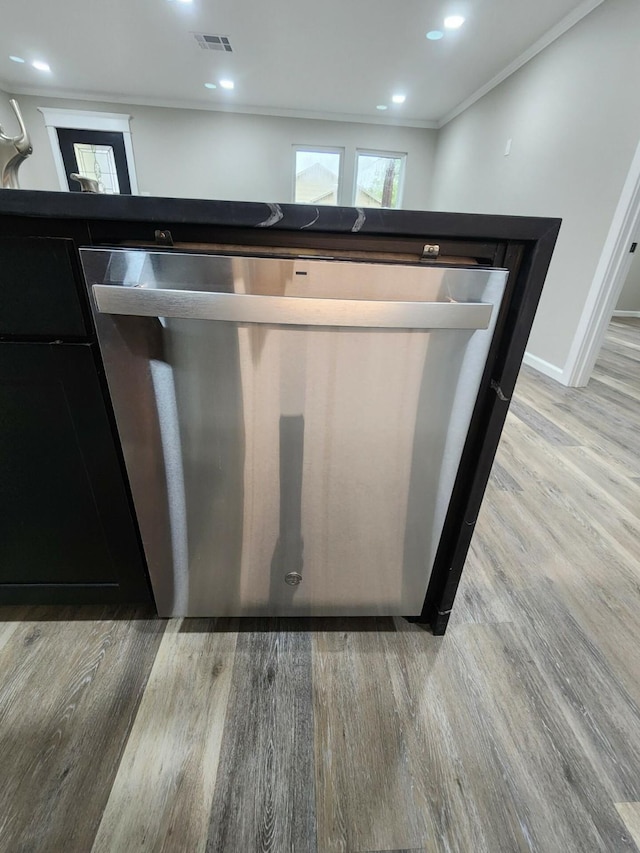 details featuring dishwasher, ornamental molding, and light hardwood / wood-style flooring